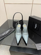 Light blue pointed-toe stiletto heels with slingback strap, glossy patent finish.