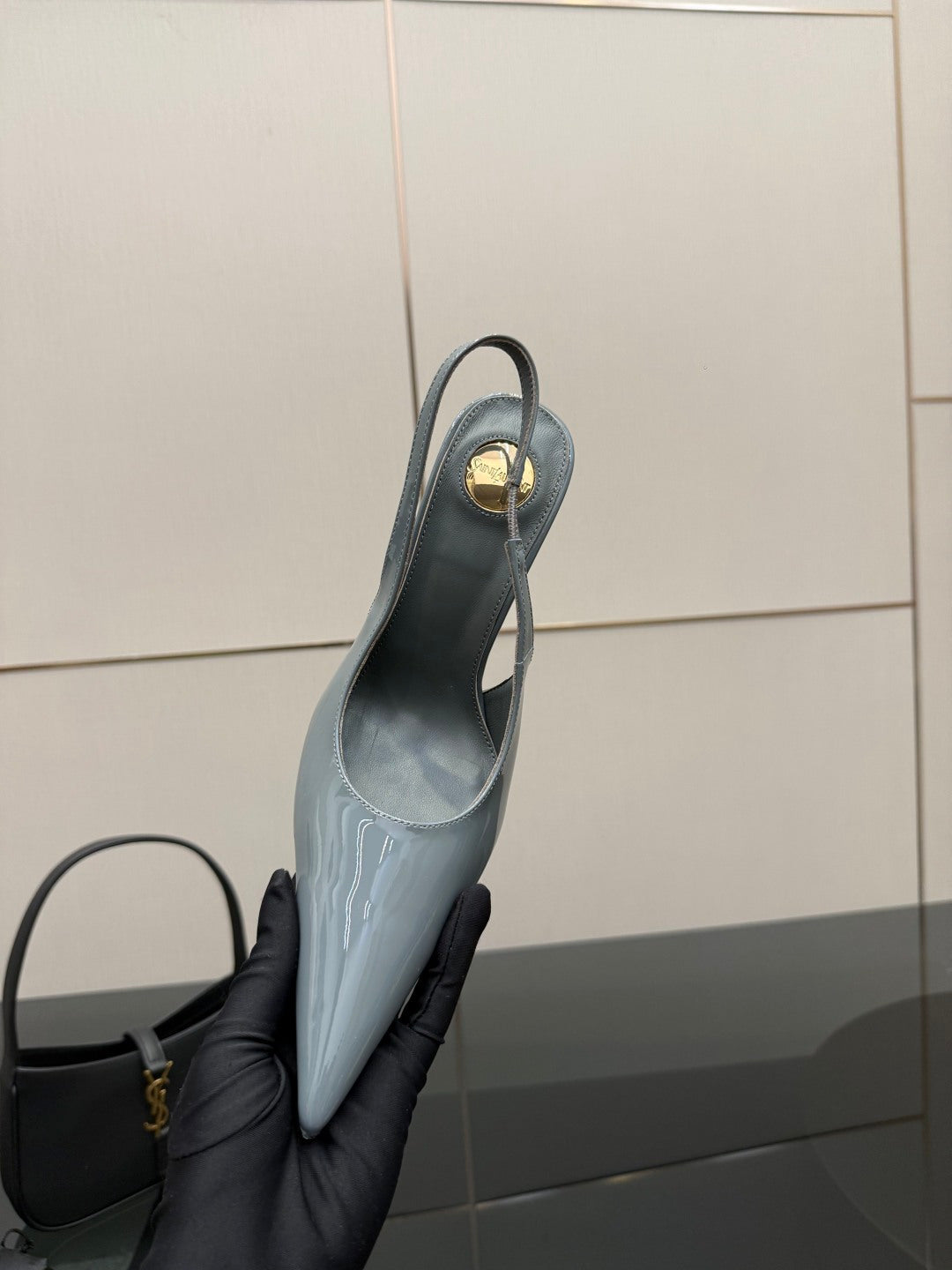 Light blue slingback stiletto heel with pointed toe, glossy finish, side view.