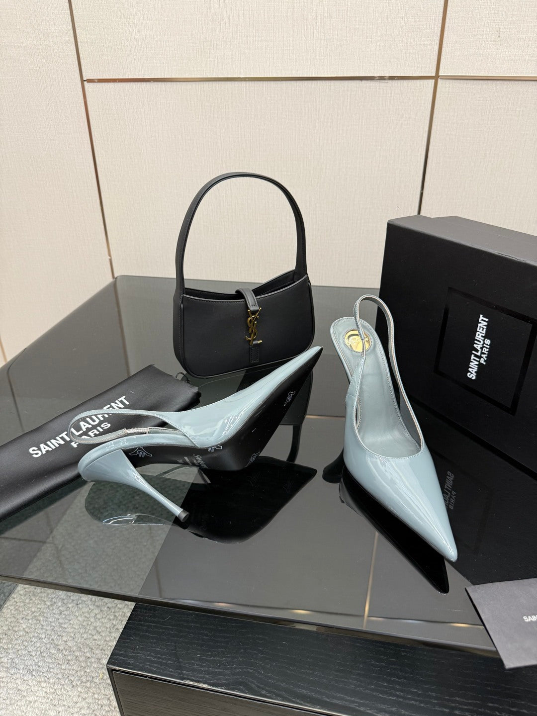 Light blue pointed-toe stiletto heels with slingback strap, shown from side view.