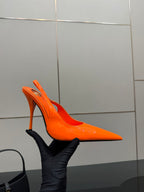 Orange pointed-toe stiletto mule pump with slim heel and glossy leather look