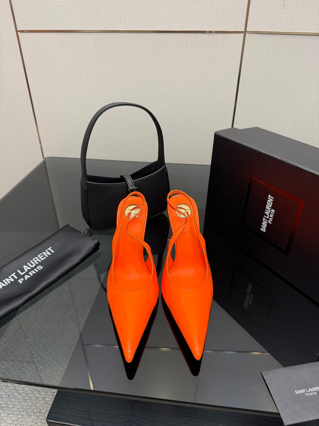 Orange pointed-toe high-heel slingback pumps with stiletto heels and glossy finish