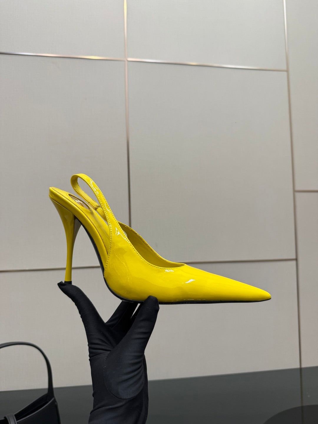 Yellow pointed-toe high-heel slingback shoe with slim heel, side view