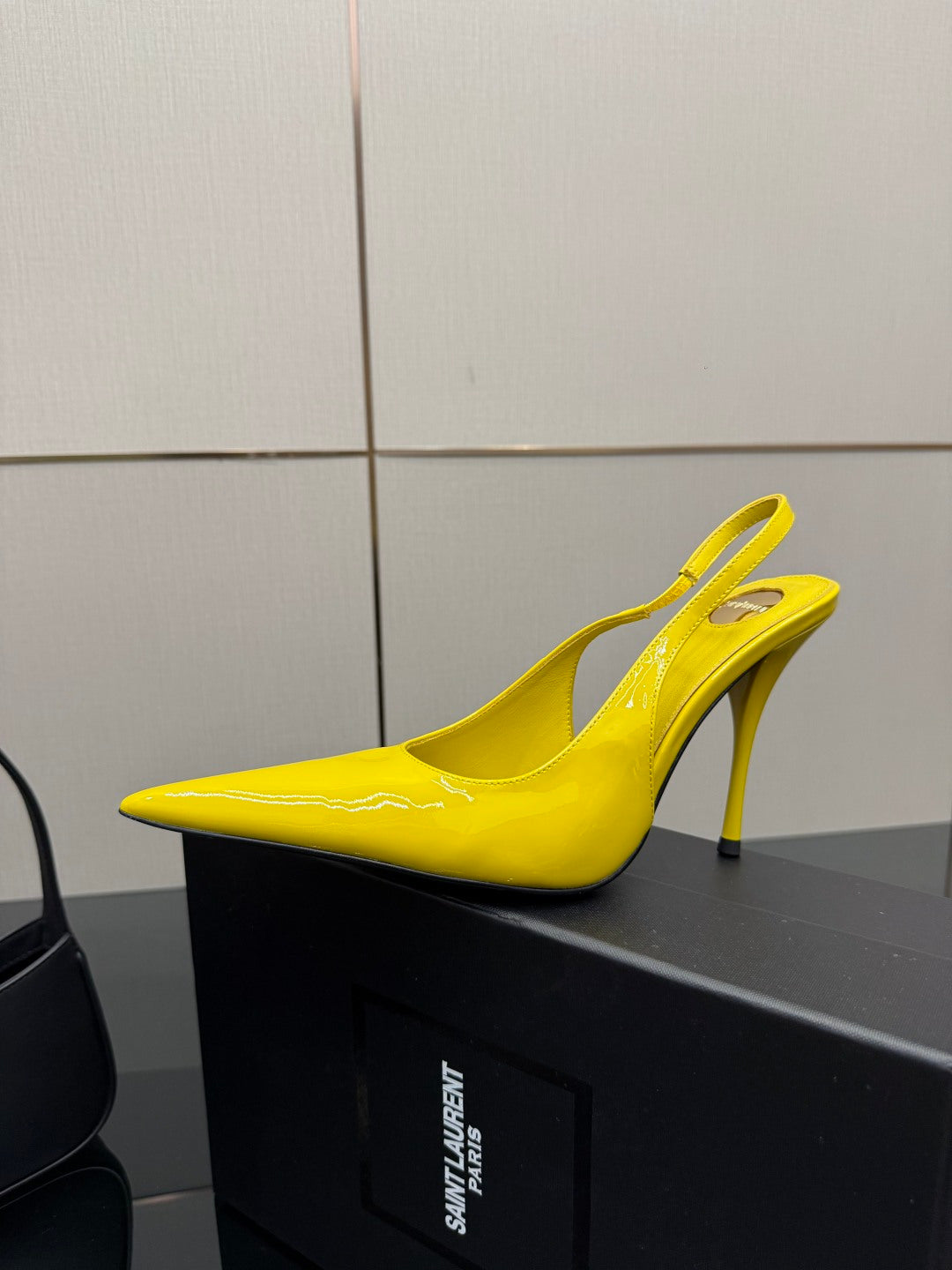 Yellow pointed-toe high-heel slingback shoe, single angled view