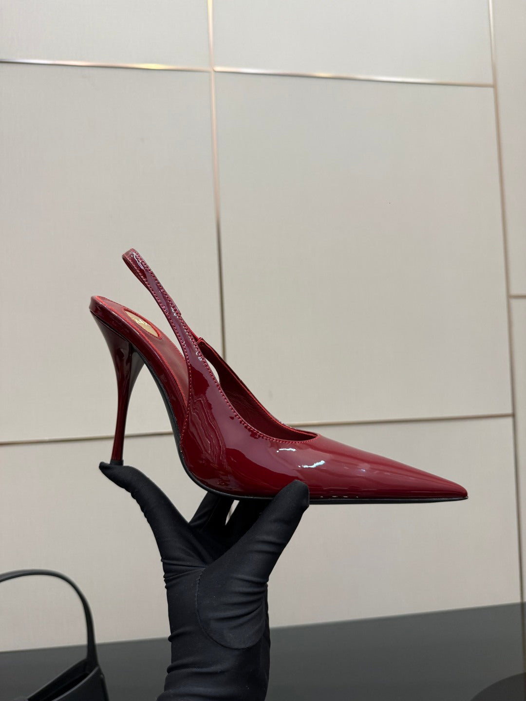 Women’s YSL red patent pointed-toe stiletto pump, angled side view, glossy upper