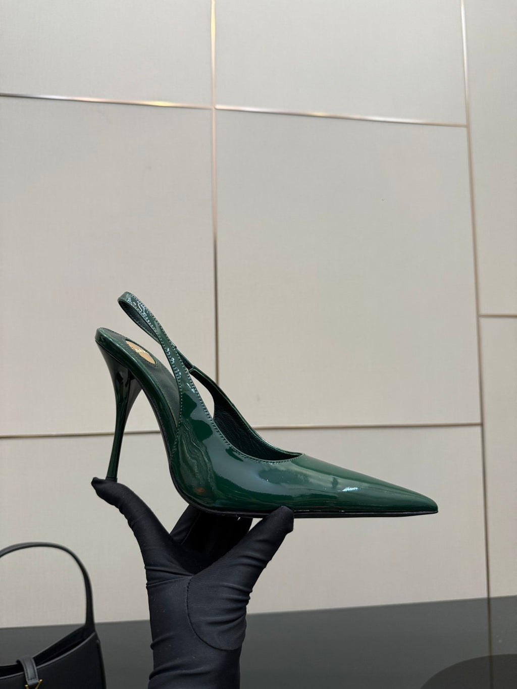 Green patent pointed-toe slingback heel with stiletto heel, angled view.