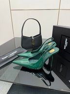 Green patent slingback high heels with pointed toe and stiletto heel, side view.