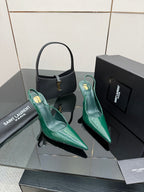 Green patent pointed-toe stiletto heels with curved slingback strap detail, angled view.