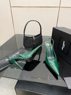 Green patent pointed-toe stiletto heels with slingback strap, front three-quarter view.