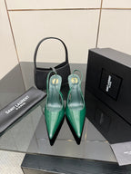 Pair of green patent pointed-toe high heels with slender stiletto heel, slip-on style.