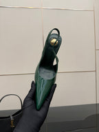 Green patent slingback heel showing inner sole and pointed toe, heel-up view.
