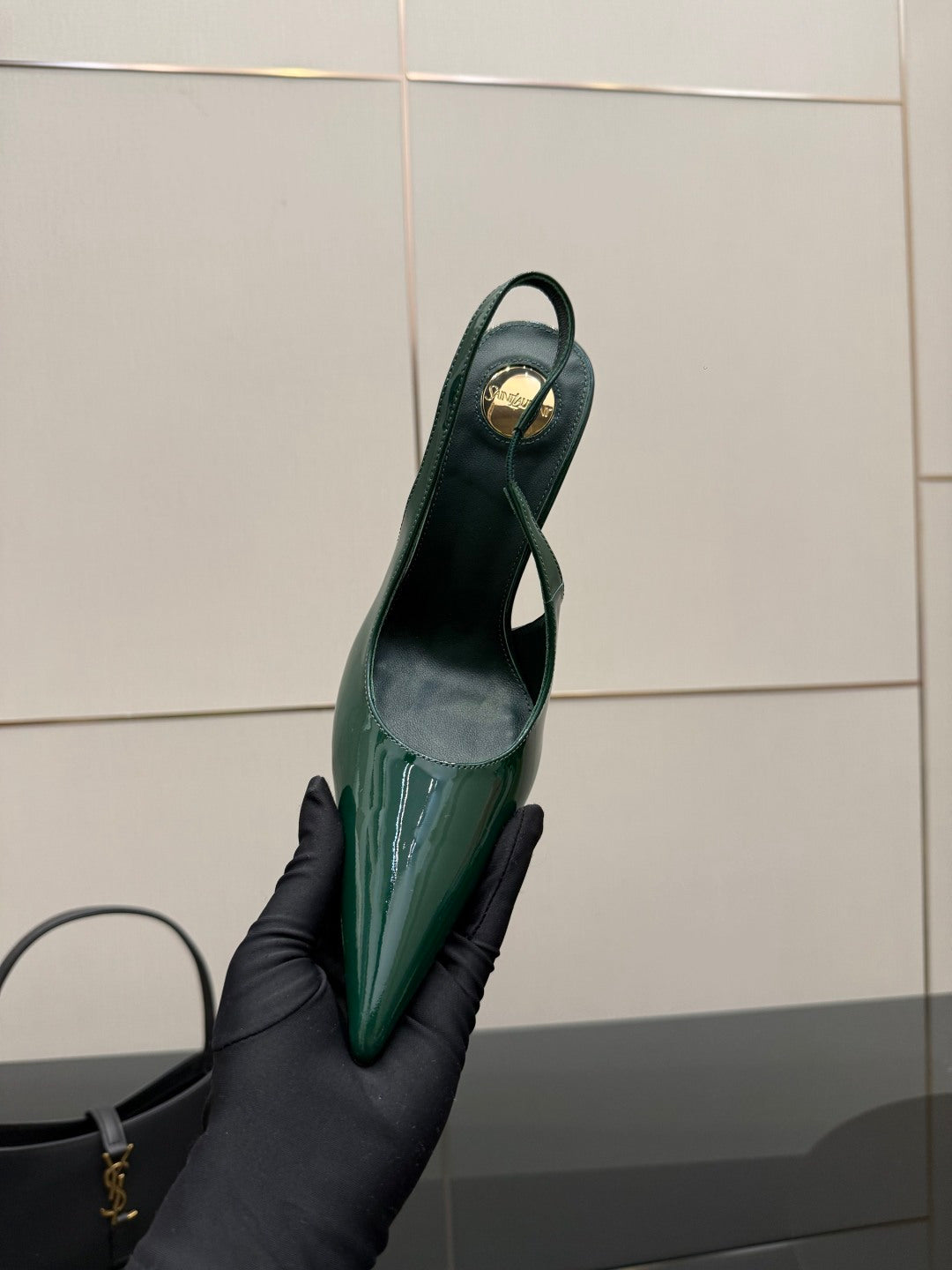 Green patent slingback heel showing inner sole and pointed toe, heel-up view.