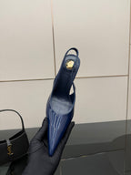 Ladies’ glossy blue pointed-toe high-heel pump held up, back view