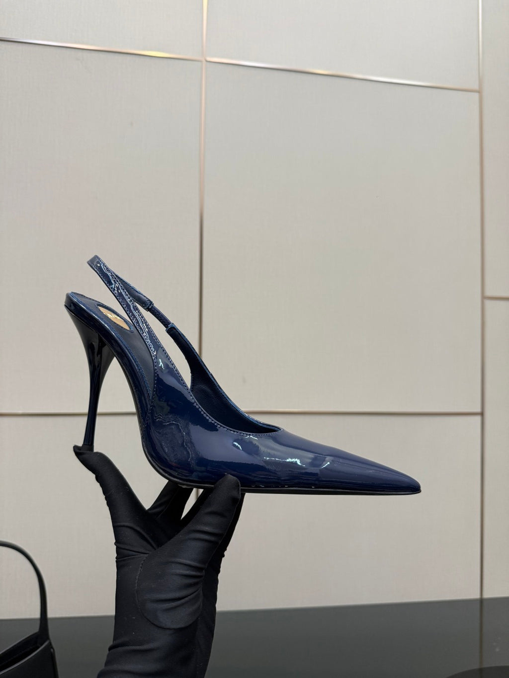 Ladies’ glossy blue pointed-toe high-heel pumps, angled side view