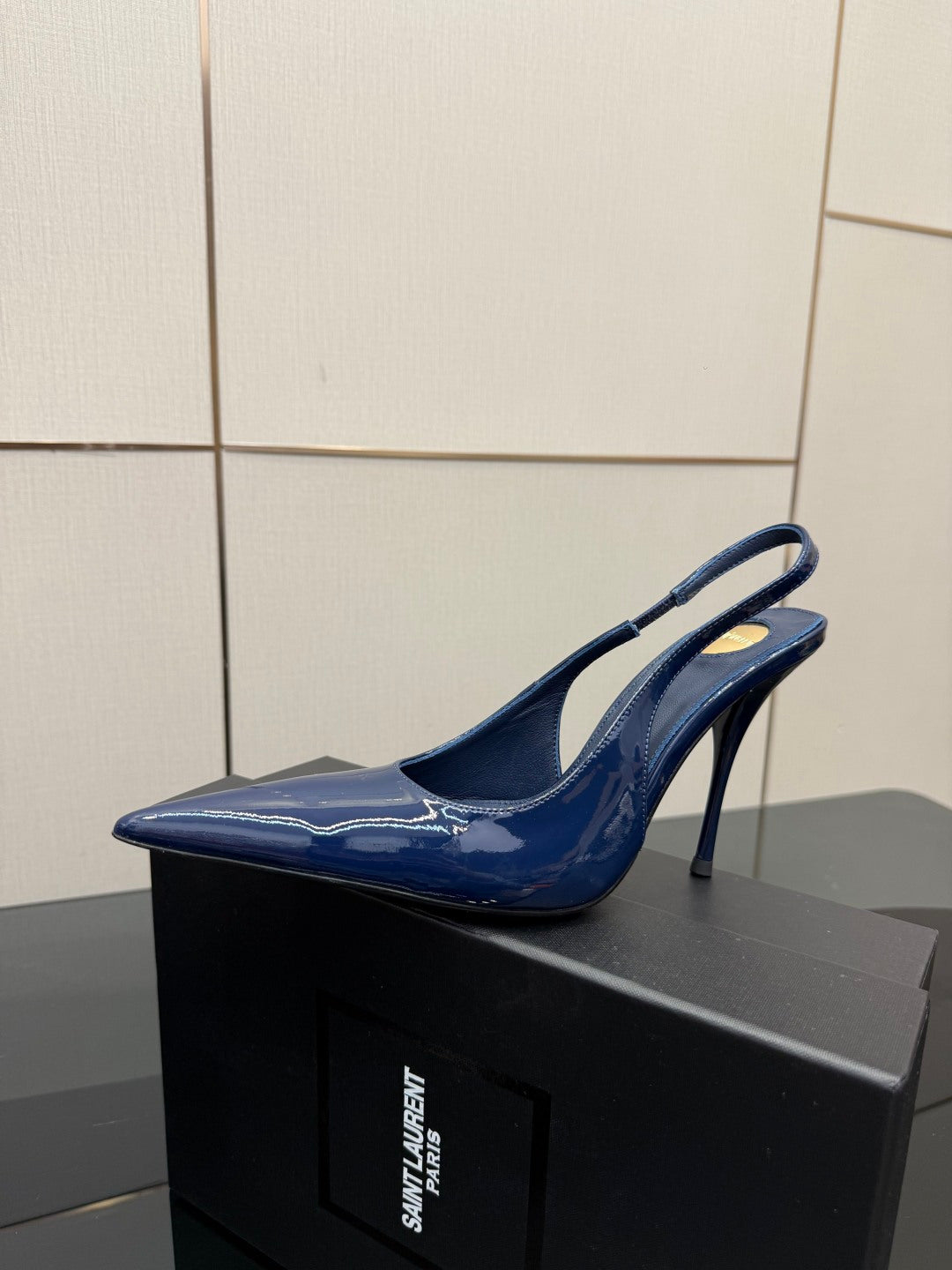 Ladies’ glossy blue pointed-toe high-heel pumps, side profile on heel