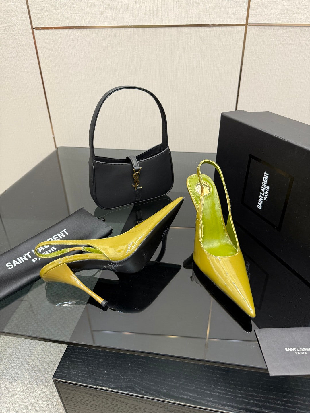 Lime-green patent pointed-toe slingback heels, angled side view on shoe box