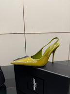 Lime-green patent pointed-toe slingback heel, single shoe profile on display box