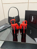 Red patent pointed-toe stiletto slingback heels, showing heels and toe shape