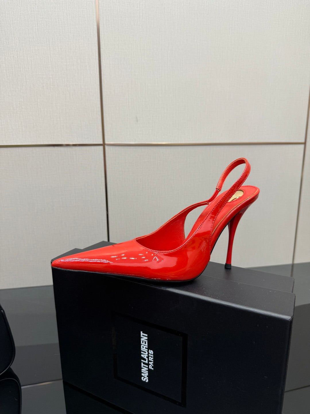 Single red patent pointed-toe stiletto slingback pump