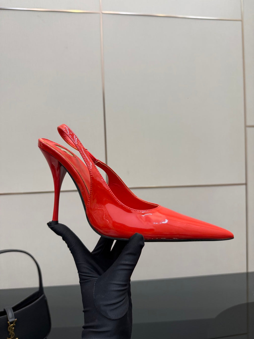 Side view of red patent pointed-toe stiletto slingback heel