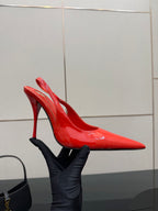 Side view of red patent pointed-toe stiletto slingback heel