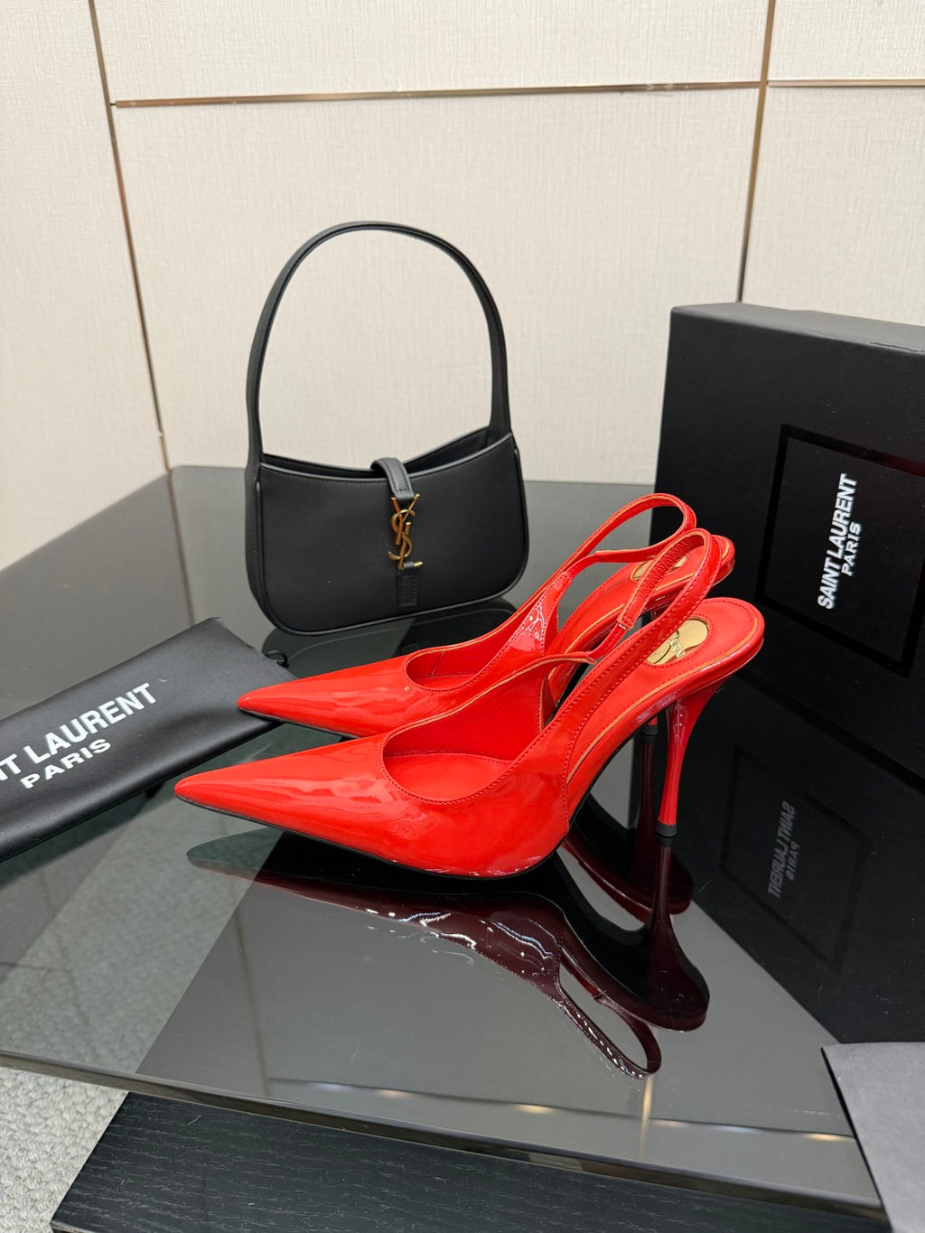 Red patent pointed-toe slingback stiletto heels on display with thin high heel