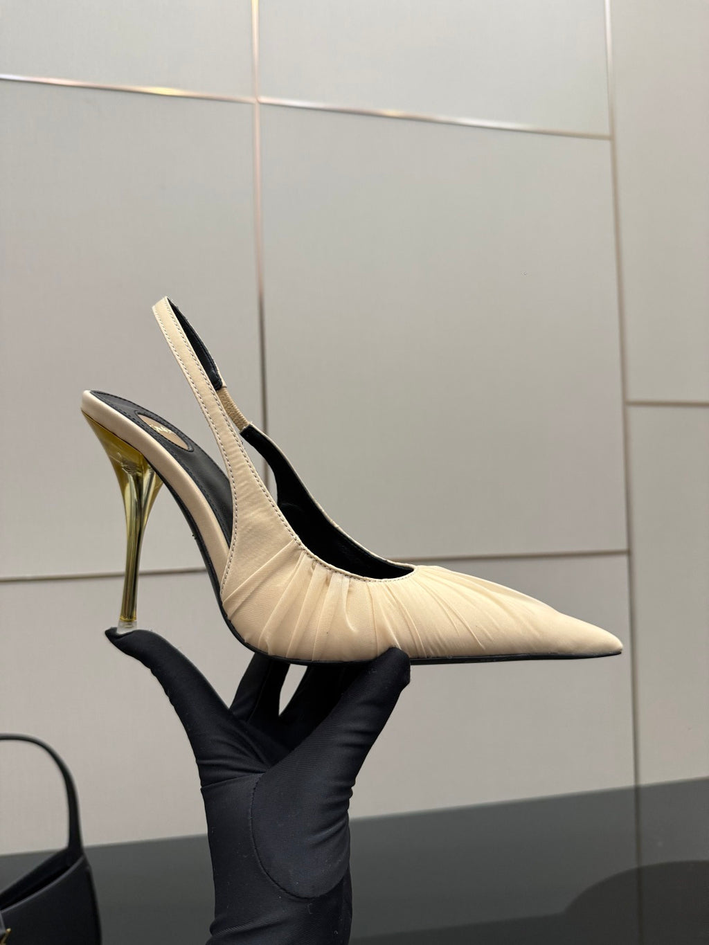 YSL slingback pump: cream upper with pointed toe and slim gold heel, side view
