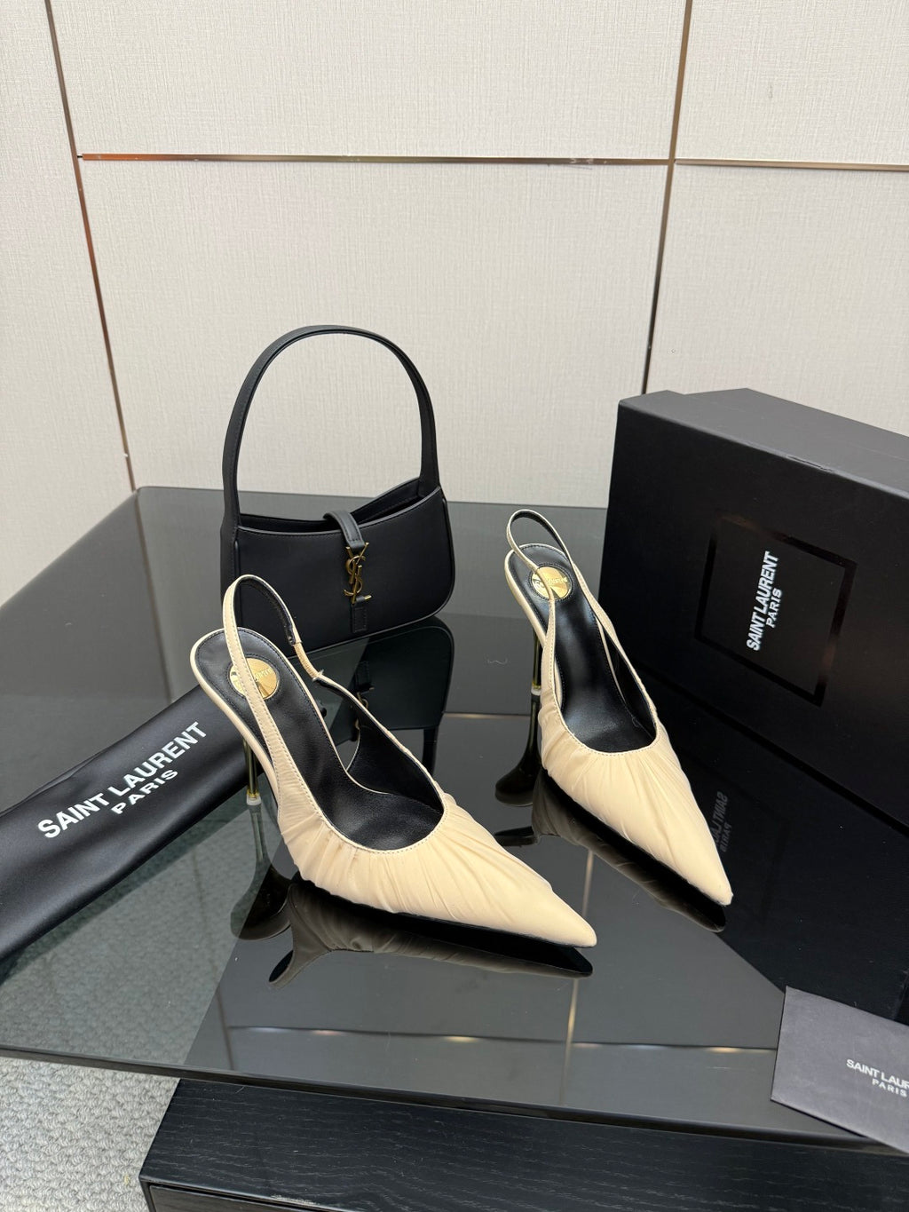 YSL slingback pumps: cream pointed-toe with slim gold heel, paired with black handbag