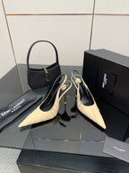YSL slingback pumps: cream pointed-toe and gold stiletto heel, with black handbag