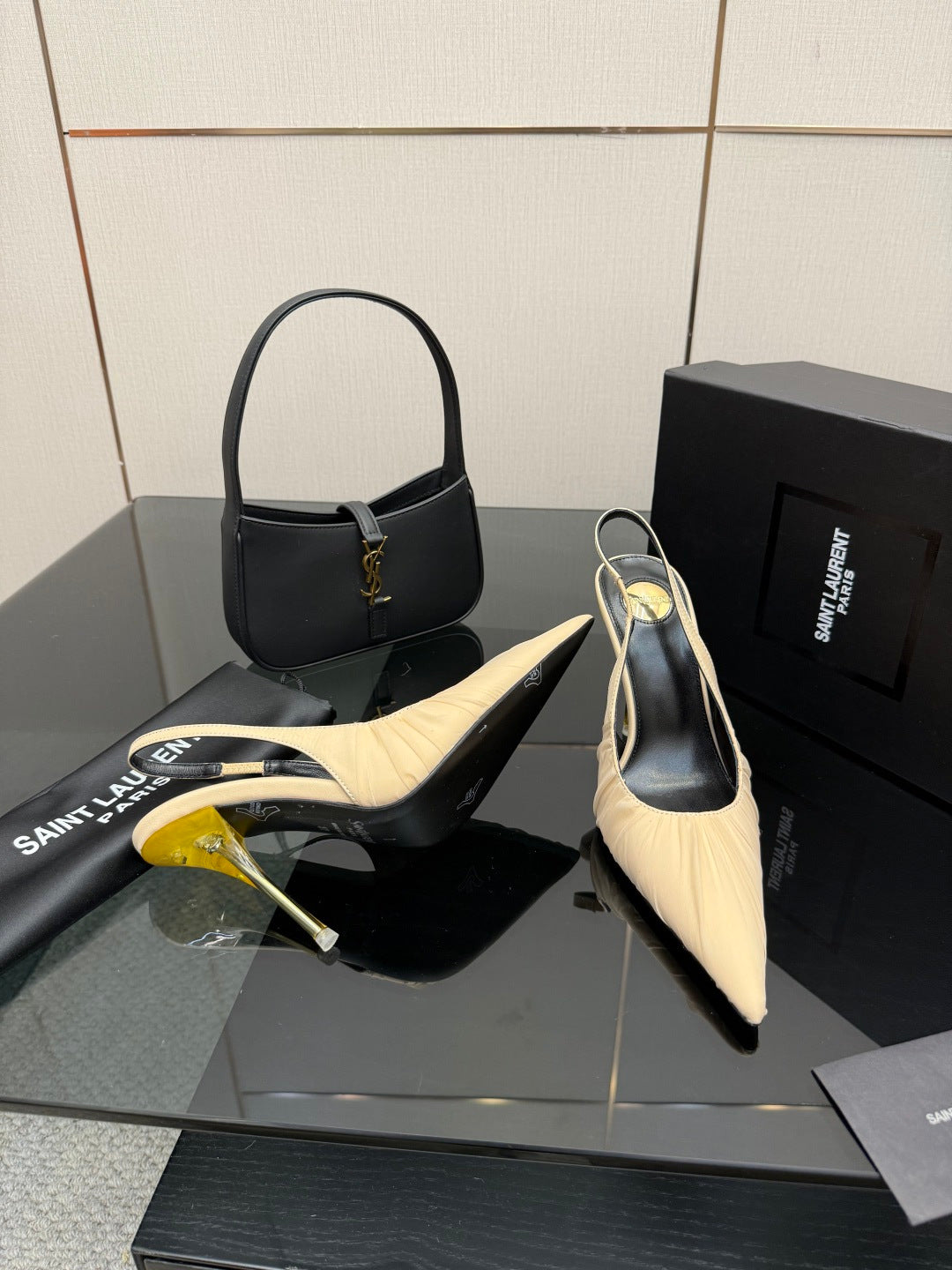 YSL slingback pumps: cream pointed toe, gold stiletto heel, shown with black handbag
