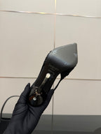 Black slingback high-heel shoe heel and side close-up, logo details visible
