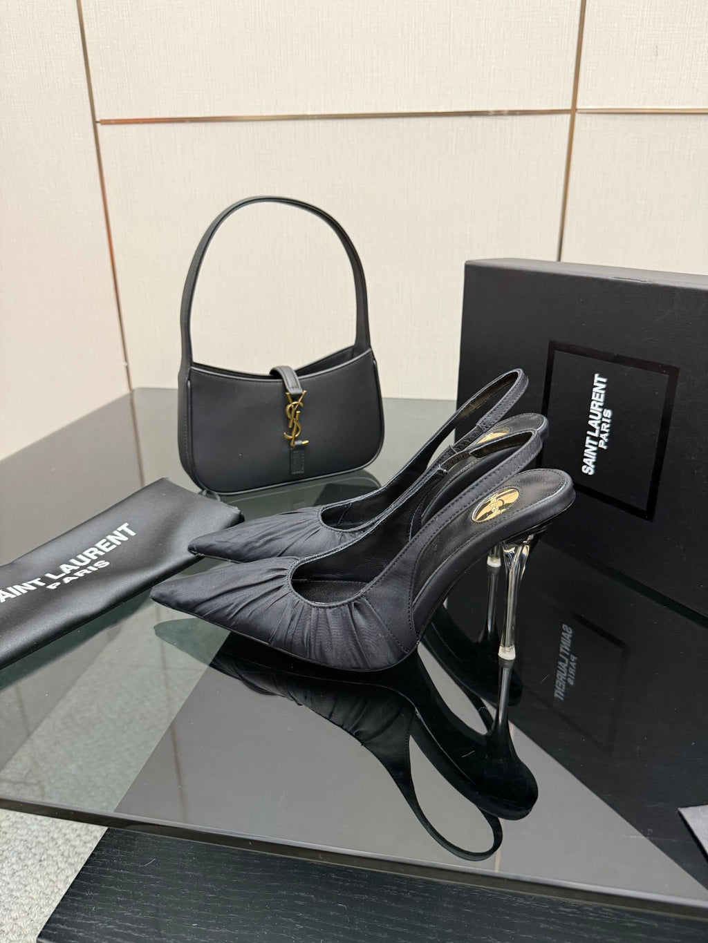 Black pointed-toe slingback high-heel shoes with silver stiletto heels