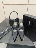 Black pointed-toe slingback high-heel shoes with stiletto heels, front view pair