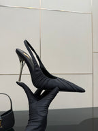 Black pointed-toe slingback high-heel shoe with silver stiletto heel, profile