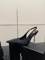 Black pointed-toe slingback high-heel shoe with silver stiletto heel, side view