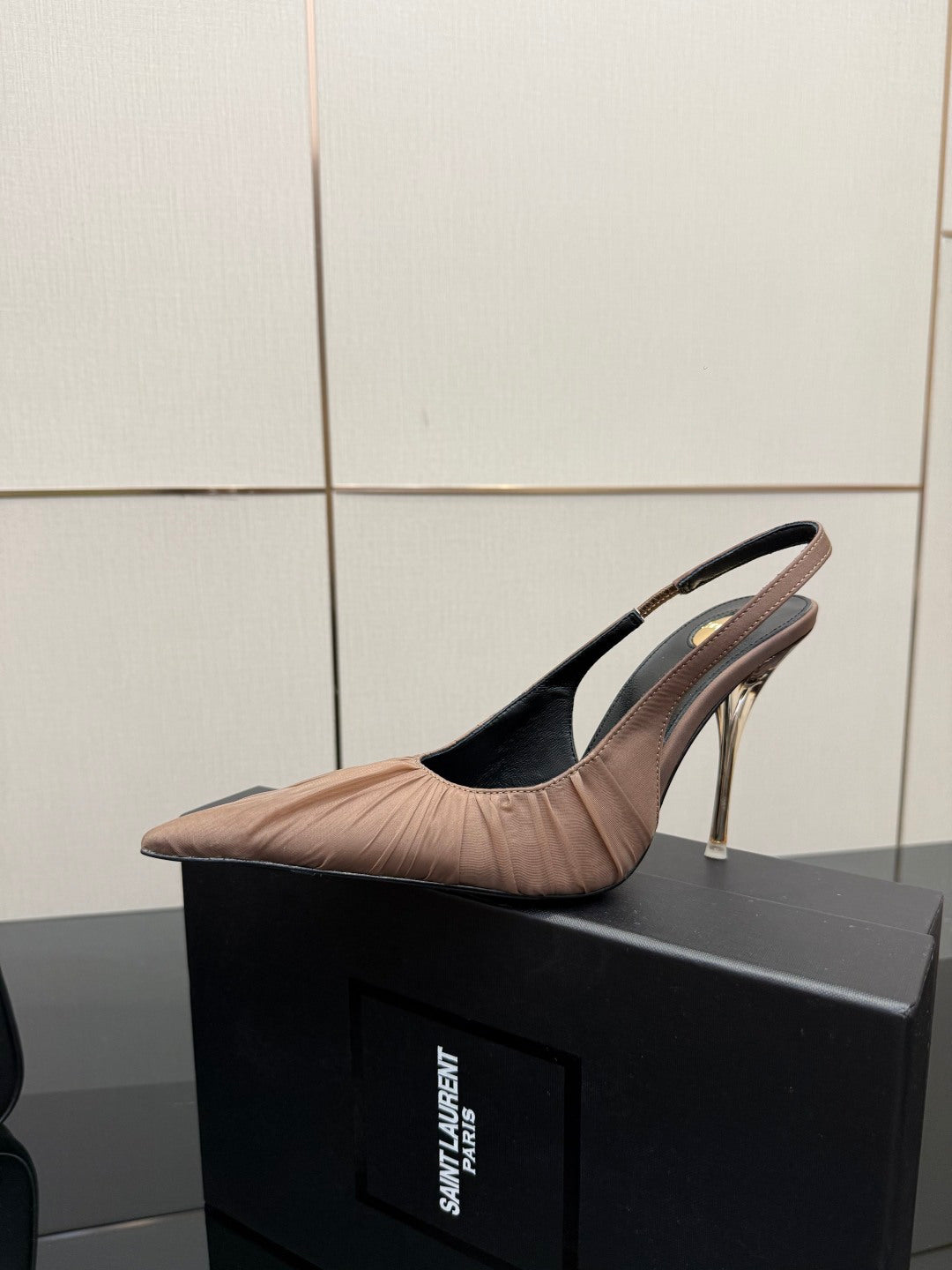 Women's nude pink slingback pump on box, pointed toe and thin gold-toned heel