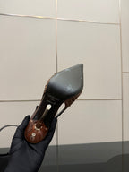 Women's nude pink slingback pump heel close-up, back strap area and stiletto profile