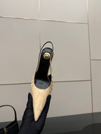 YSL slingback pump on heel view: cream upper with black lining and gold-toned heel