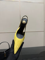 Yellow pointed-toe slingback stiletto heel shoe showing heel and black interior
