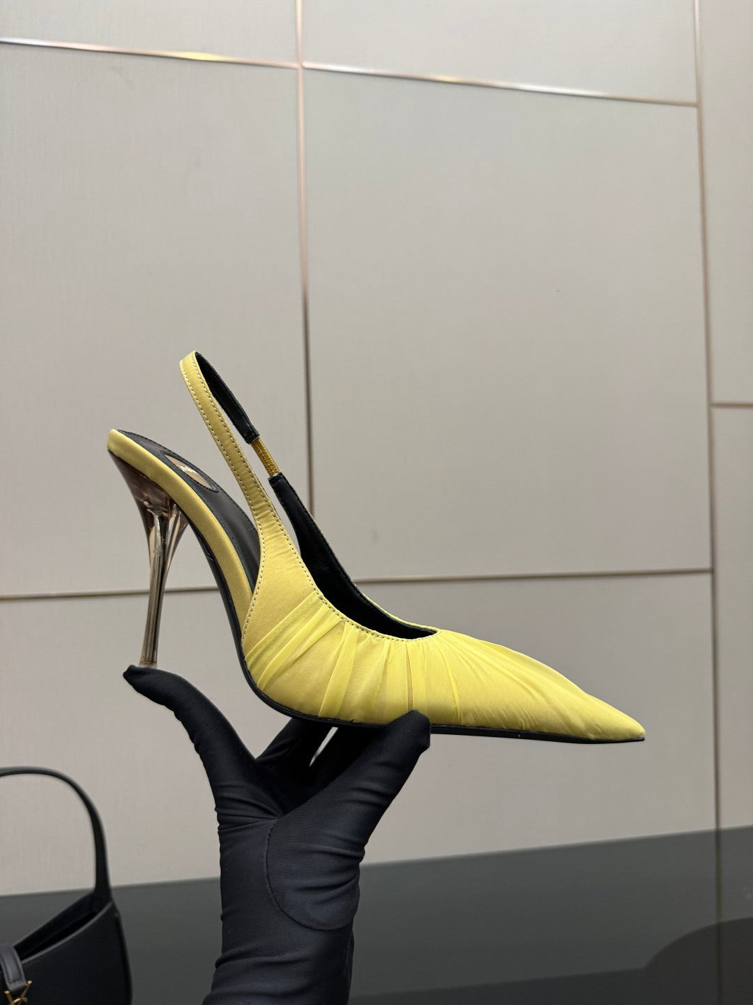 Yellow pointed-toe slingback stiletto heel pair from side view, tall metallic heels