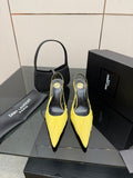 Yellow pointed-toe stiletto heels with slingback strap, black insole, pair on display