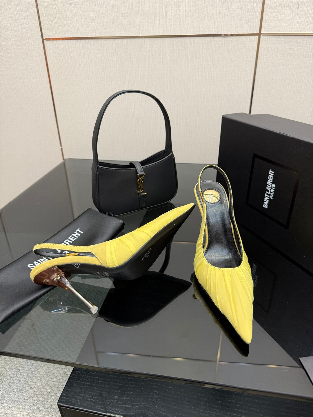 Yellow pointed-toe slingback stiletto heels with black insole and tall clear-look heel