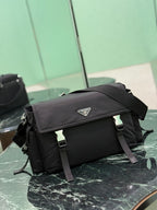 Black Prada messenger bag side view with front flap and adjustable shoulder strap.