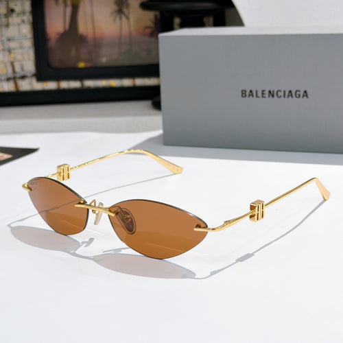 Balenciaga sunglasses with amber-brown lenses and gold metal frames