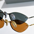 Balenciaga sunglasses close-up: amber and dark lenses on metal frames
