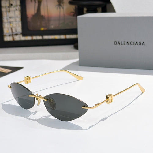 Balenciaga sunglasses with dark gray lenses and gold metal frames