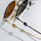 Balenciaga sunglasses, gold and gunmetal frames with brown and dark lenses