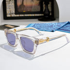 Clear square sunglasses with purple-tinted lenses and gold-tone logo on arms