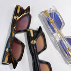 Assorted sunglasses: dark frames with tinted lenses and clear blue frame with purple tint