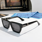Black square sunglasses with dark lenses and gold-tone logo detail on the arms