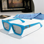 Blue square sunglasses with tinted lenses and gold-tone logo detail on the arms